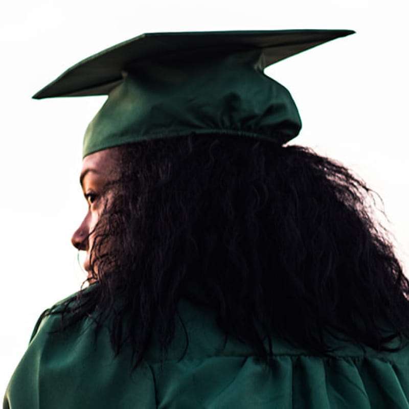 Mental health post grad life, young black female in a green cap and gown | e-Surgery