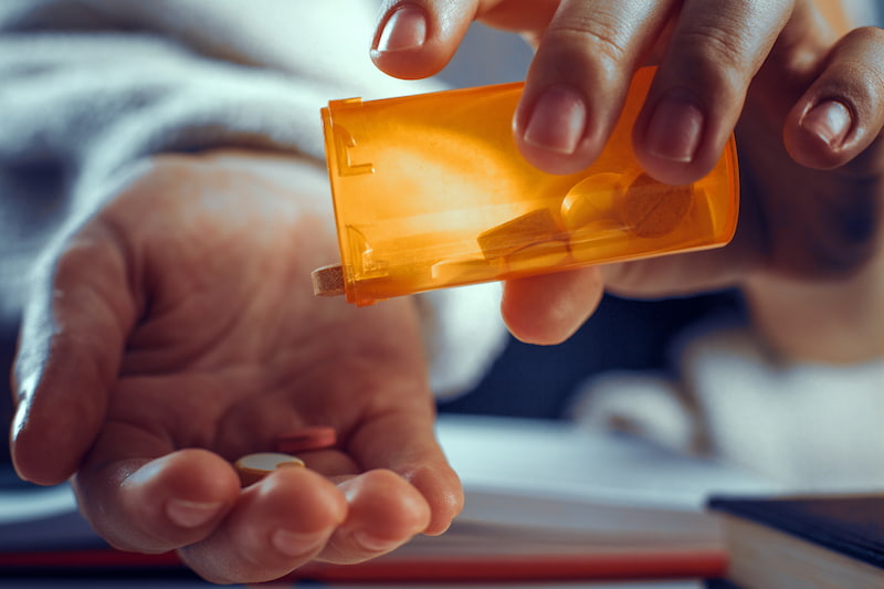 Man taking Omeprazole pills 