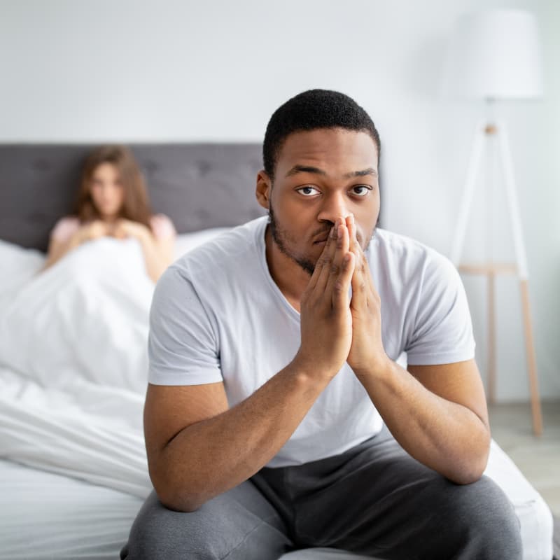 man sat on edge of bed wondering if he can take priligy and viagra | e-surgery